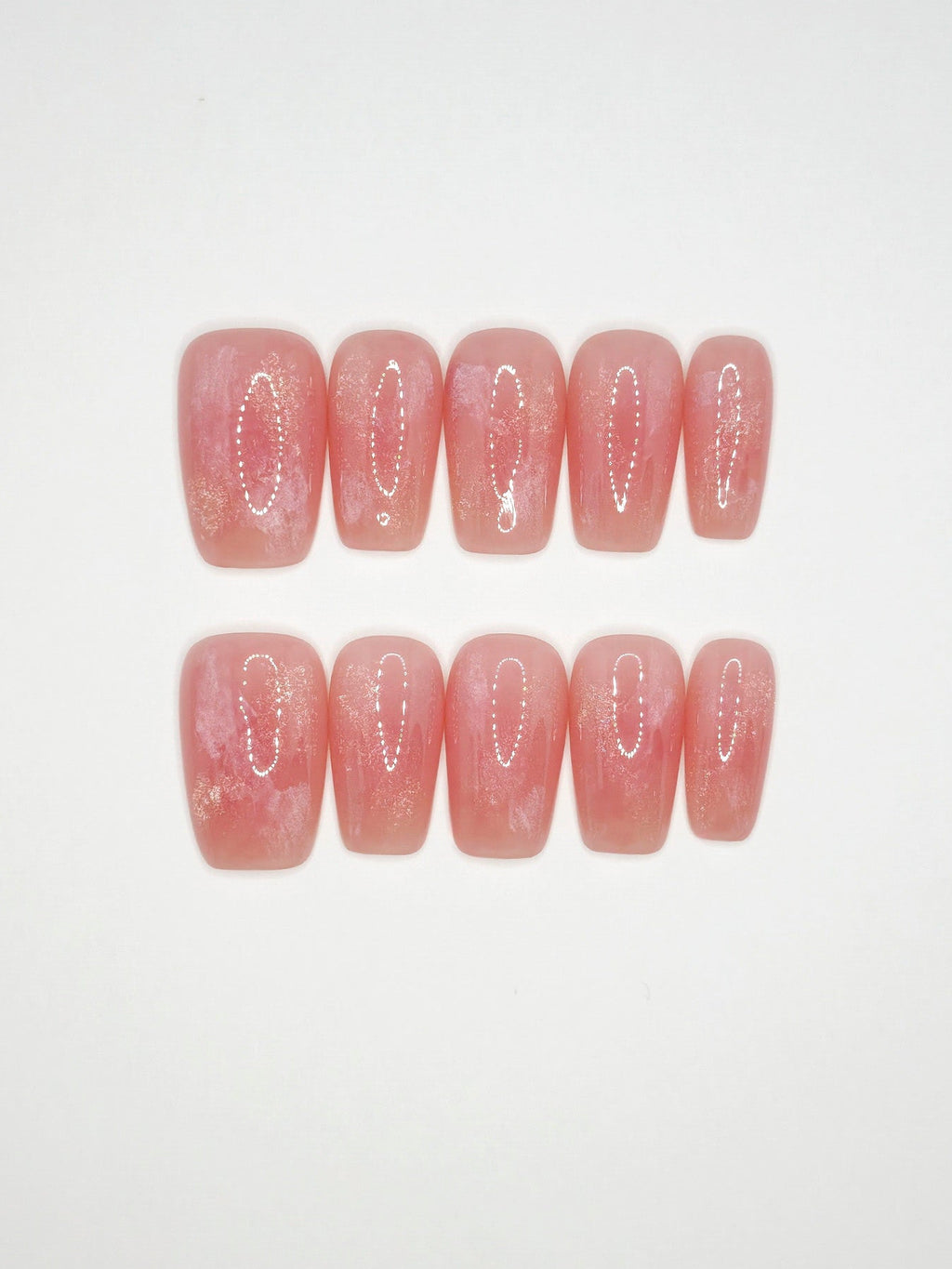 Set of pink press-on nails with decorative cutouts on a white background