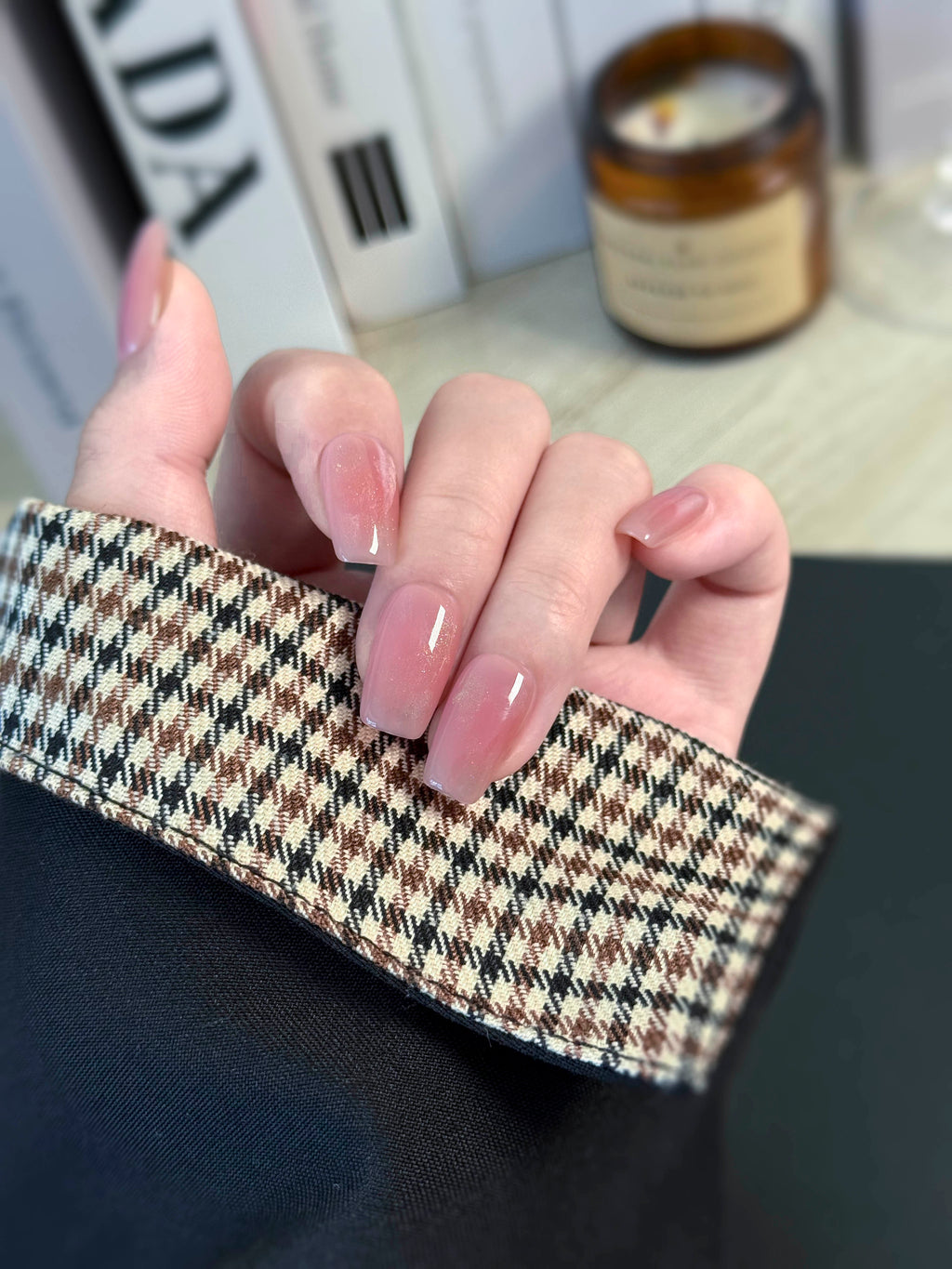 Hand holding a checkered fabric with a blurred background
