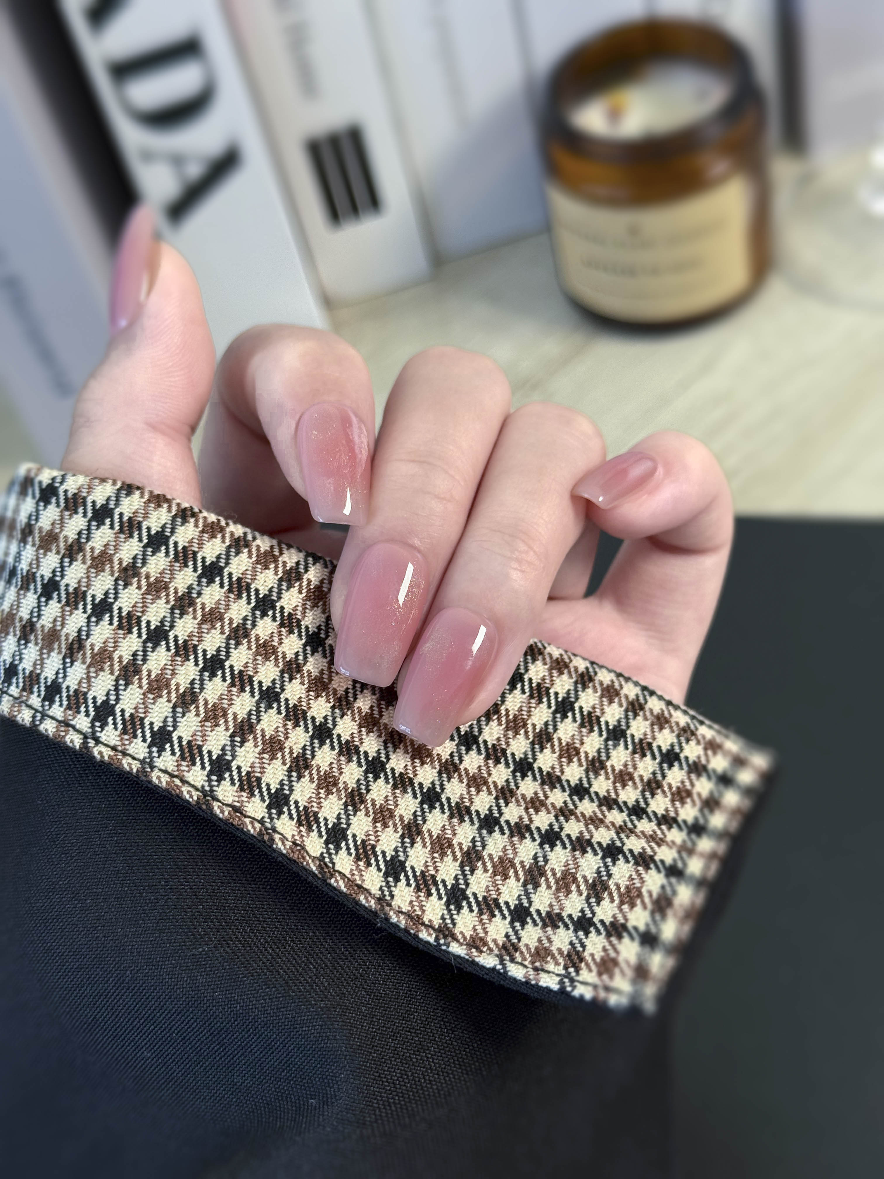 Hand holding a checkered fabric with a blurred background