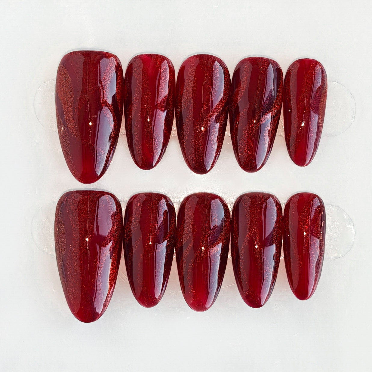 Red nail polish on a white background