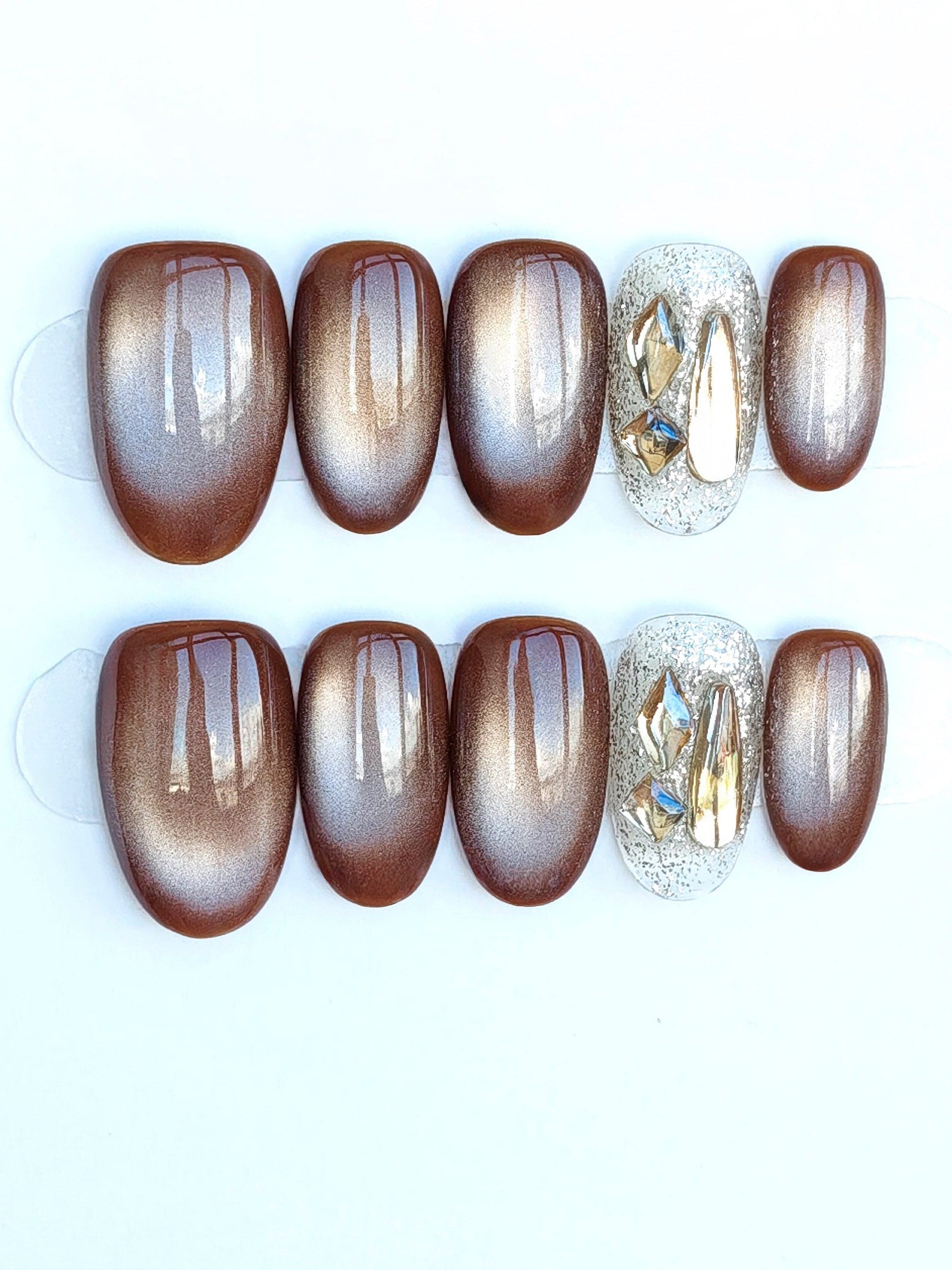 Set of ombre nail art designs on a white card with a blurred background