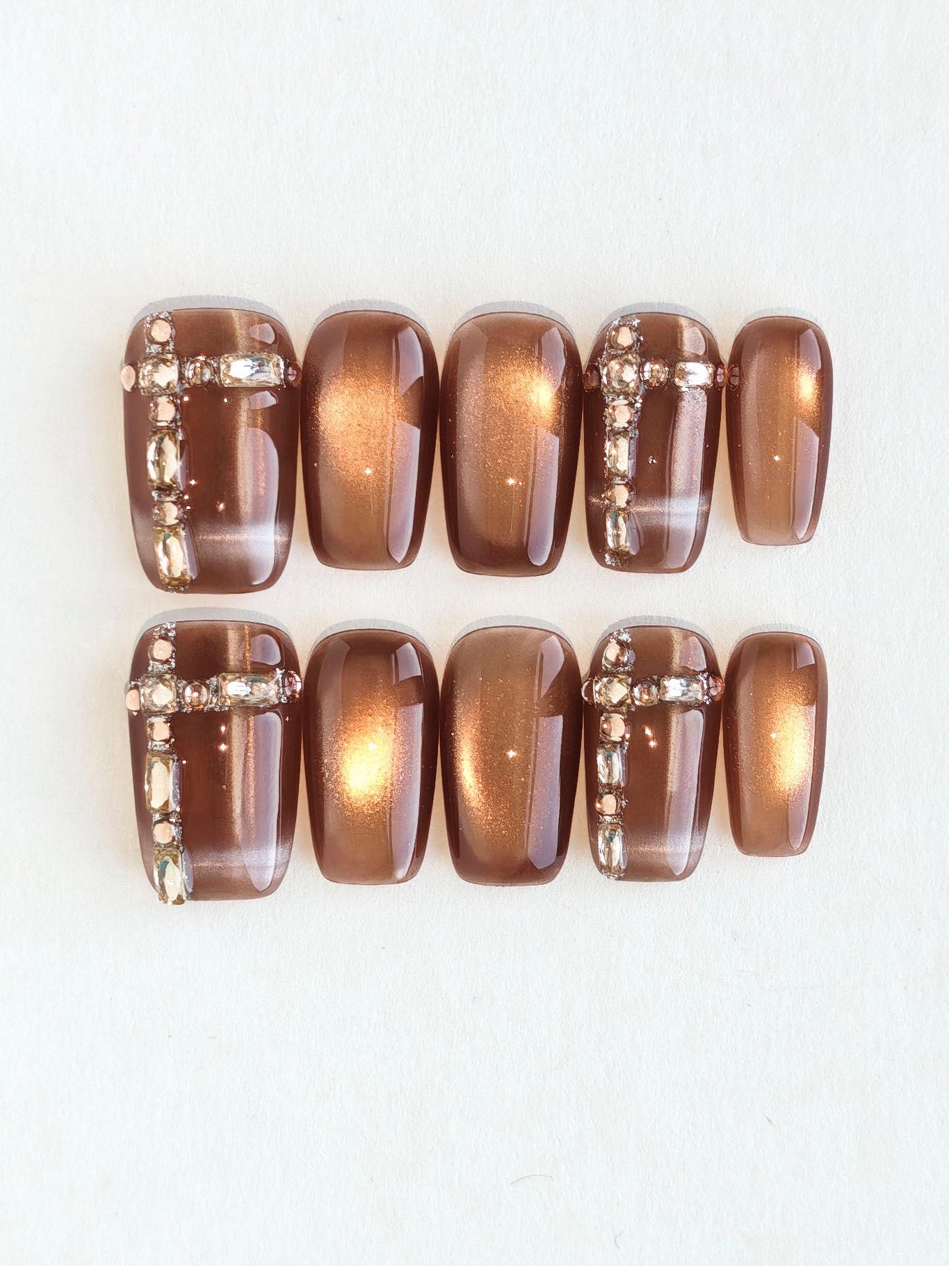 Set of brown nail polish bottles on a white background