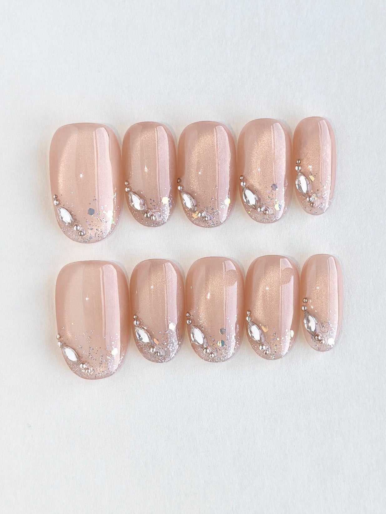 Set of beige nail art designs on a light gray background