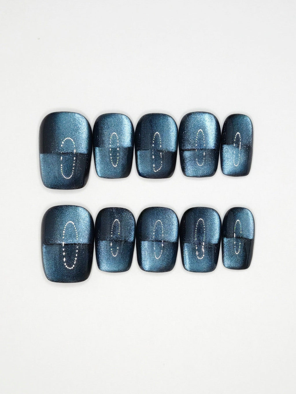 navy nails arranged in a straight line on a white background