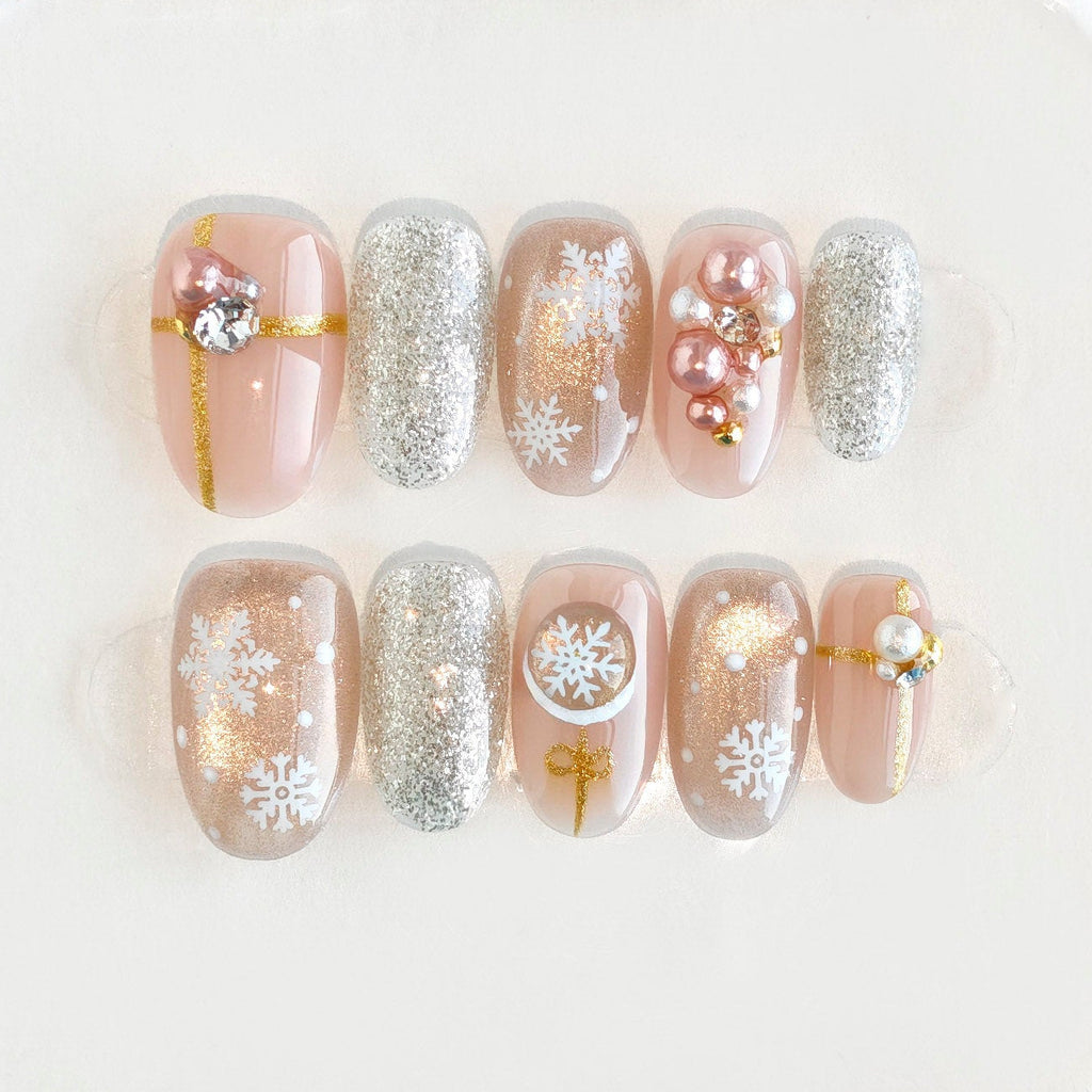 Set of pearl and crystal earrings in a clear jewelry case on a white background