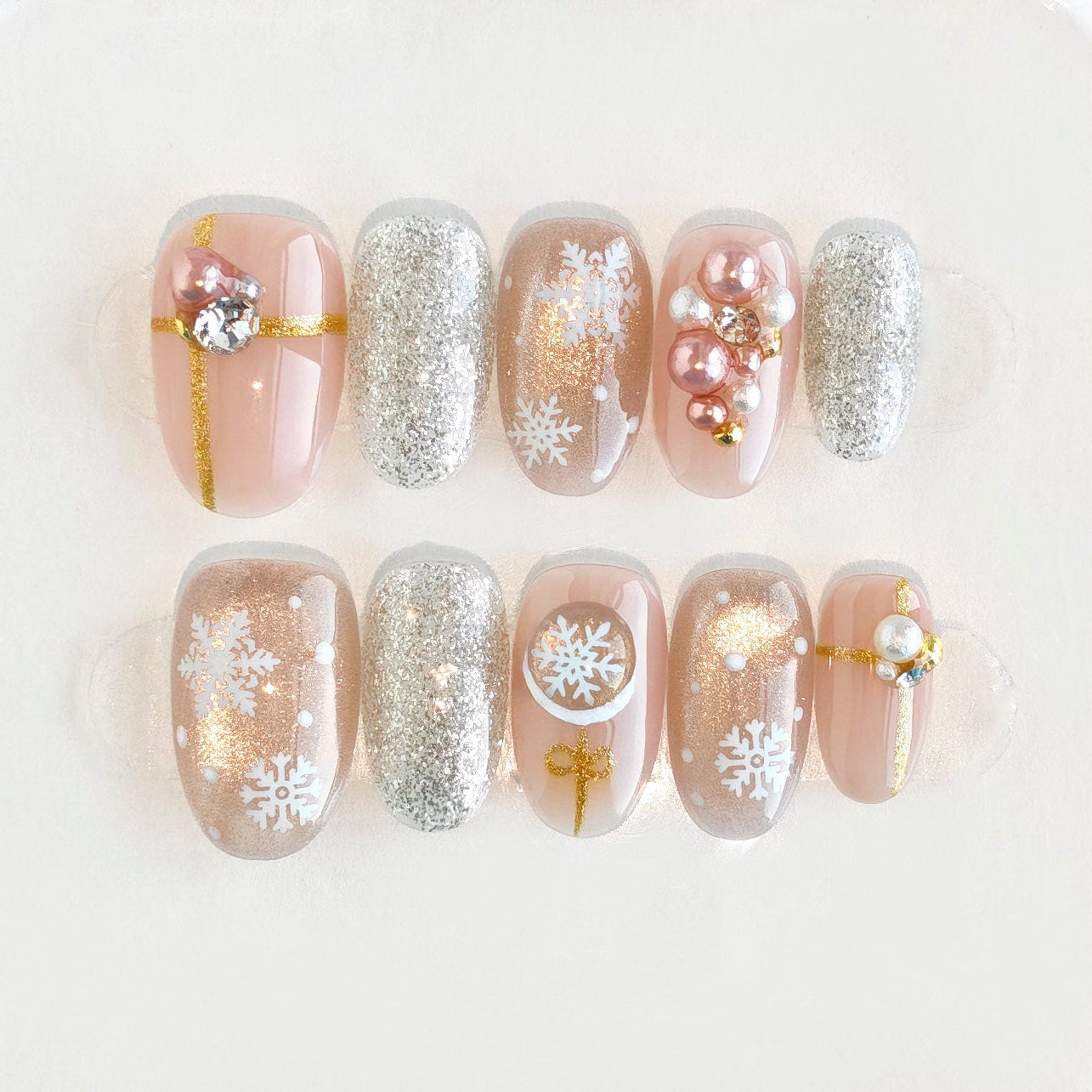 Set of pearl and crystal earrings in a clear jewelry case on a white background